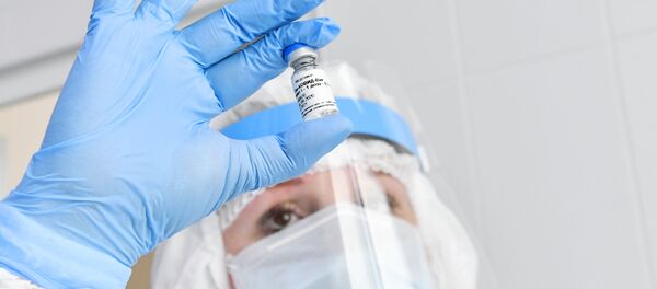 Медсестра держит в руках ампулу с российской вакциной Гам-Ковид-Вак от коронавируса - Sputnik Lietuva