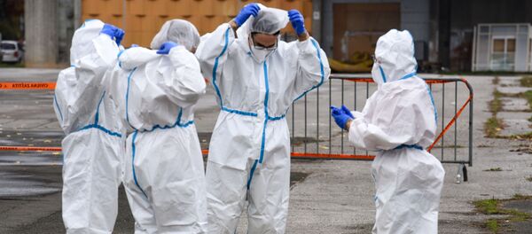 Медики в защитных костюмах Медики в защитных костюмах - Sputnik Lietuva
