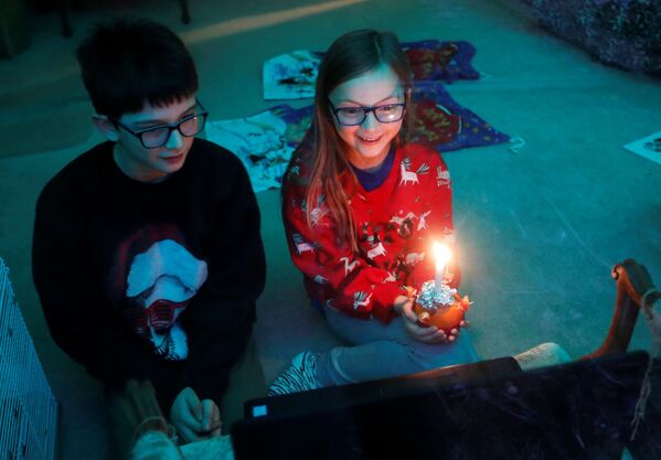 Дети во время онлайн-служения Christingle в канун Рождества в Блэксли, Великобритания - Sputnik Литва