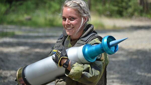Женщина-военнослужащий армии Швеции несет снаряд во время танковых испытаний Strong Europe - Sputnik Литва