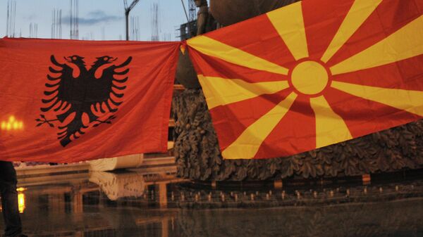 Участники акции протеста с флагами Македонии (справа) и Албании в центре македонской столицы Скопье - Sputnik Литва