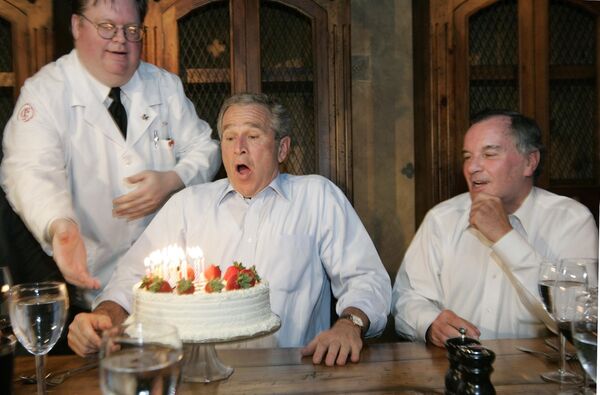 JAV prezidentas Džordžas Bušas ruošiasi užpūsti žvakes ant savo gimtadienio torto, 2006 metų liepos 6 d. - Sputnik Lietuva