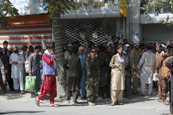 Žmonės Kabulo banke laukia savo eilės atsiimti pinigus. Pareigūnai sako, kad Talibano kovotojai atvyko į Kabulą ir siekia besąlygiško centrinės valdžios pasidavimo. - Sputnik Lietuva