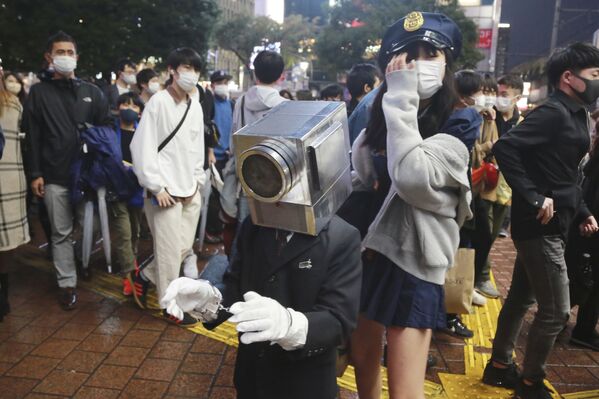 Žmonės, pasipuošę kūrybingais Helovino kostiumais, vaikšto per populiarų Tokijo Šibujos rajoną. - Sputnik Lietuva