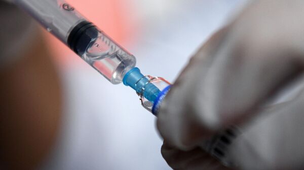 Медицинский работник набирает в шприц препарат от коронавирусной инфекции Гам-Ковид-Вак (Спутник V), архивное фото - Sputnik Литва