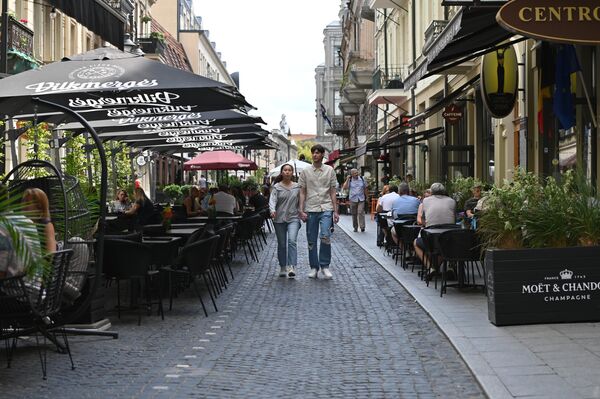 На улице Вильняус, где располагается большое количество баров и уличных кафе, посетители заведений предпочитают занимать столики на открытой террасе. - Sputnik Литва
