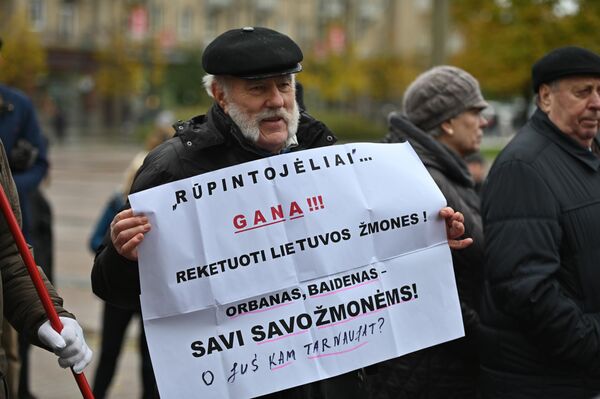 Люди вышли с плакатами и флагами, требуя отказаться от введения нового налога.Надпись на плакате: &quot;Заботливые, хватит рэкетировать своих граждан! Орбан и Байден свои для своих граждан. А вы кому служите?&quot; - Sputnik Литва