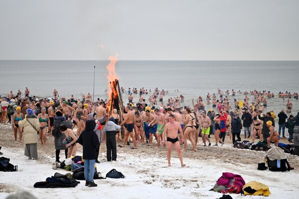 В ознаменование юбилейного купания на пляже разожгли три костра – по одному на каждое десятилетие. - Sputnik Литва