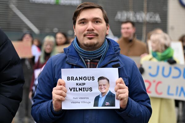 Участник акции протеста с плакатом &quot;Дорогой, как Вильнюс. Начиная с лета по всему Вильнюсу&quot; с изображением мэра литовской столицы Валдаса Бенкунскаса. - Sputnik Литва