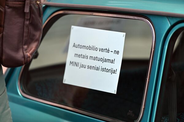 На фото: надпись на плакате: "Ценность автомобиля измеряется не годами! Мини — уже давно история". На фото: надпись на плакате: "Ценность автомобиля измеряется не годами! Мини — уже давно история". - Sputnik Литва