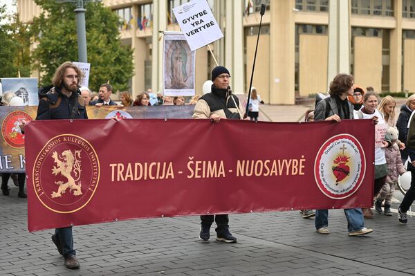 На фото: участники марша несут плакат с надписью: &quot;Традиция — семья — собственность&quot;. - Sputnik Литва