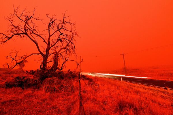 Автомобильная трасса в дыму от лесного пожара на окраине Кума, Австралия, 2020 год - Sputnik Lietuva