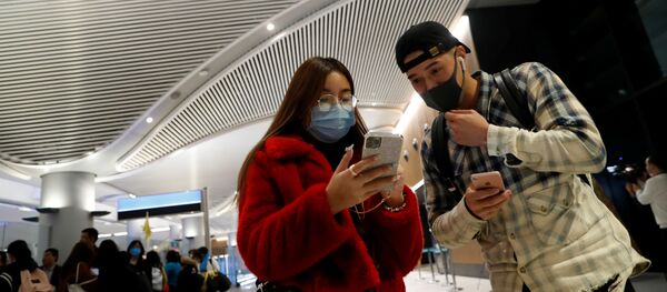 Пассажиры в масках прибывают прямым рейсом из Китая в международный аэропорт Стамбула, 24 января 2020 года - Sputnik Литва