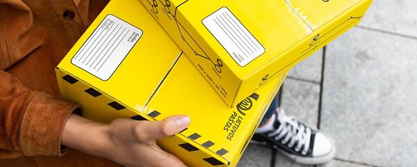 Девушка держит коробки с посылками, архивное фото Девушка держит коробки с посылками, архивное фото - Sputnik Литва