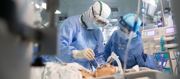 Медики работают с пациентом в больнице в Ухане - Sputnik Литва