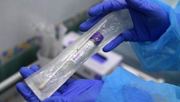 Пробирка с тестом на коронавирус в руках у сотрудницы в медицинской лаборатории, архивное фото - Sputnik Литва