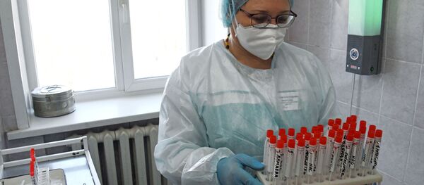 Врач держит в руках пробирки с образцами биоматериалов - Sputnik Литва