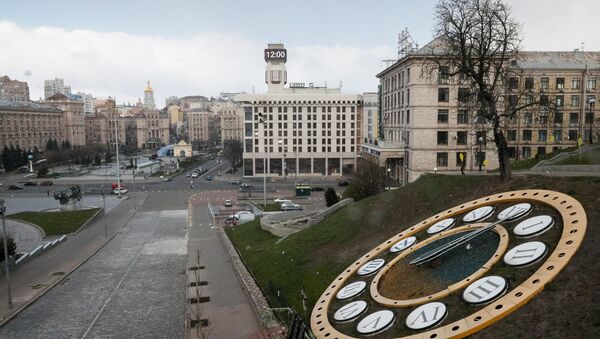 Показывающие полдень часы на фоне опустевшей площади Майдан Независимости в Киеве в период пандемии коронавируса - Sputnik Литва