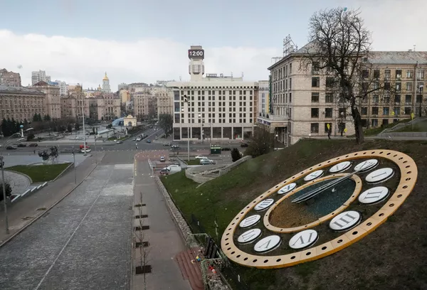 Показывающие полдень часы на фоне опустевшей площади Майдан Независимости в Киеве в период пандемии коронавируса - Sputnik Lietuva