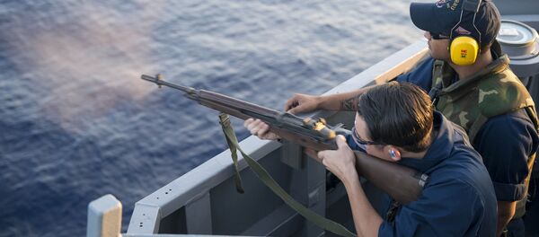 Человек стреляет из полуавтоматической снайперской винтовки M14 - Sputnik Литва