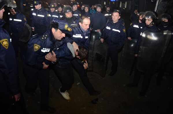 Сотрудники полиции задерживают одного из участников уличных беспорядков в курортном городе Батуми - Sputnik Литва