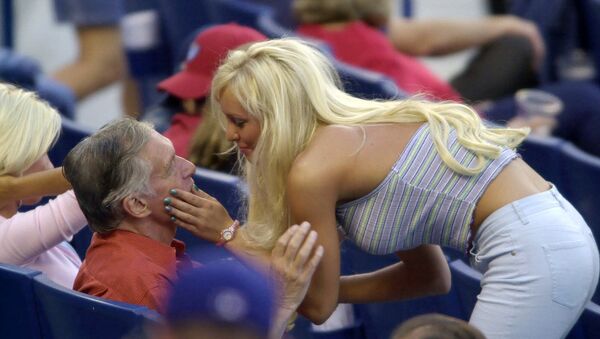 Хью Хефнер разговаривает с девушкой из Плейбой, во время бейсбольного матча на Доджер стадион, 2001, Лос-Анджелес, Калифорния, США. - Sputnik Литва