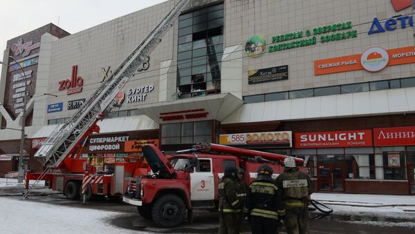 Сотрудник пожарной охраны МЧС во время тушения пожара в торговом центре «Зимняя вишня» в Кемерово - Sputnik Lietuva