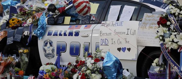 Цветы и флаги в память о погибших на служебной машине в Далласе, Техас, США Цветы и флаги в память о погибших на служебной машине в Далласе, Техас, США - Sputnik Lietuva