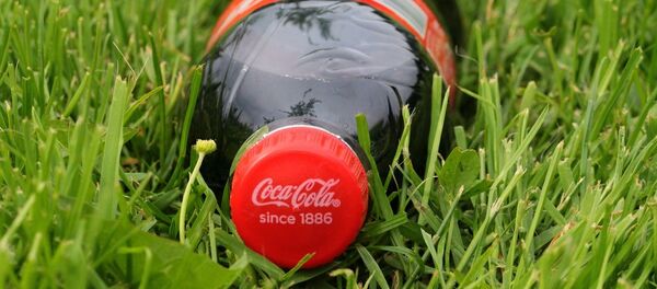 Банка напитка Coca-Cola в траве Банка напитка Coca-Cola в траве - Sputnik Литва