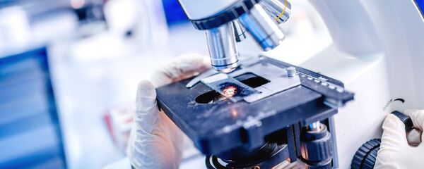 Ученый работает с микроскопом, архивное фото - Sputnik Литва